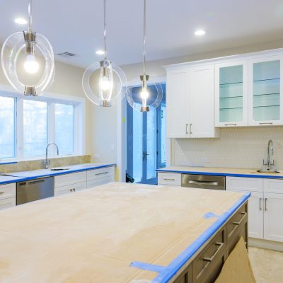 White of kitchen wooden cabinets with contemporary look of installation base for island in center